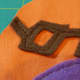Sew pieces onto the front piece of the toy's body fabric.