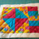 This mug rug is quilted using diagonal lines marked on the quilt.