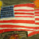 Painting of an American flag with acrylic paint with the fireworks done in oil pastels. Then a watercolor wash was added to the background. Very nice effect!