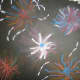 Fireworks art done with oil pastel on black construction paper