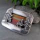 This sunset jasper stone set from the back creates a color-banded sky behind the dimensional forest trees balanced by a smooth, polished silver frame.