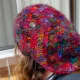 The back of the hat is floppy and shows off the sari yarn colours well.