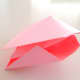 Press the bottom flaps together again and tuck the folded corners of one flap in between the layers of the other flap.