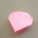 Close the paper and press down on the corners which are at the top of the folded paper.