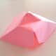 Push the top of the paper downwards to make a small indentation.