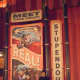 My husband with one of the posters in Storybook Circus Fantasyland in Magic Kingdom