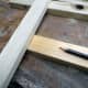 Using the timber as a template to mark the correct position for the joint