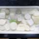 The old soap bars to be recycled laid out ready for chopping into small bits.