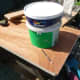 Using the base of an emulsion paint pot to mark out the curve I wanted for the inner curve of shelving.