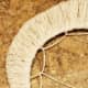 Repeat the same process of threading and pulling the twine with each of the loops you created.