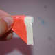 Fold the trangle in half with the sticky part on the outside.
