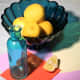 A still life set up with turquoise blue glass and lemons for the painting &quot;Lemons and Teal.&quot;