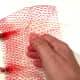 Stretchy net from avocados or onions. Pleat or scrunch an edge to be the enclosed bottom of this little bag.