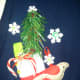 My husband's cotton sweater vest with Christmas ornaments hot glued on.