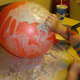 Dip the paper in the paper mache glue and apply in layers to the balloon.