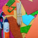 Acrylic paint, a brush, six ice cream sticks, a glue stick, scissors, a few sheets of colored, textured, and shiny paper.