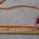 Measure the length of rope needed to fit snuggly around the wrist