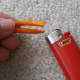 Using a lighter, singe the ends of the rope together to prevent fraying
