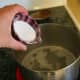 Add 3 tbsp. washing soda to 2 cups water. Bring the solution to a boil, then remove from heat.