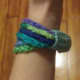 Multi-coloured chain stitch bangle with band.