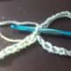 Make a chain with the colours you want, as long as you want your cuff to be. slip stitch first colour through first loop and make a chain long enough to go around your wrist.