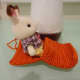 Third step: Sit down and start inserting your legs into the blanket. Wiggle your body until your legs reach the end.