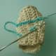 Crocheting through the dc post, sideways, and working 2 sc in each dc post. Here is my hook inserted through the next dc post.