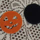 Orange face ready to hot glue onto the black backing.