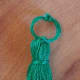 Tiny tassels can be made exactly as large ones, except downsized. This one is made without embelishments, strictly out of thread.