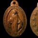 This carving of the Miraculous Medal is on two sides of a walnut panel. On small faces, palm tools are preferred over long-handled tools.
