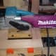 Sanding the drawers flat with a belt sander