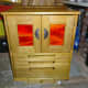 Completed sewing machine cabinet in workshop with doors and lid closed