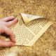 Tear out 12 pages from your old book. Roll each page starting from the bottom right corner to the top left corner.