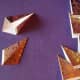 With right side down, fold each side of the tile in, meeting the diagonal crease in the center.