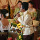 Two Khmer singers, representing heavenly beings, symbolically cleanse the wedding couple of their past.