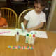 My sons painting their cupcake wrappers with Do-A-Dot bottles.