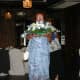 A happy Wedding Reception Trivia Game winner taking her prize centerpiece home at the end of the reception!