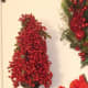 A Red Berry Christmas topiary adds color and elegance to your decor.