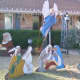 Santa Bows to Jesus in back of display
