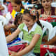 A girl opening her shoebox in Ecuador.