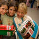 Girl holding their shoeboxes at an OCC distribution event in Uruguay.