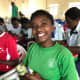 A girl opening her shoebox in Rwanda.