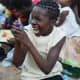 A girl holding one of her shoebox gifts in Malawi.