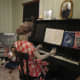 An example of ways a family entertained themselves in the 1940s. At Christmas time, they would gather around the piano to sing carols.