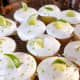 Top the frosting with fresh slices of lime and grated lime zest.