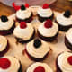Moist chocolate cupcakes with vanilla frosting topped with fresh red raspberries and blackberries