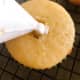 I like to remove a bit of cake from the center of each cupcake top to fill it with frosting.