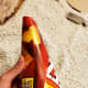 Roll a rectangular piece of cardboard into a cone shape to create a form for your hat.