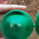 String a piece of dental floss through the two holes in the top of the plastic Easter egg.