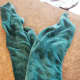 Fold in half creating a V shape with the corners.